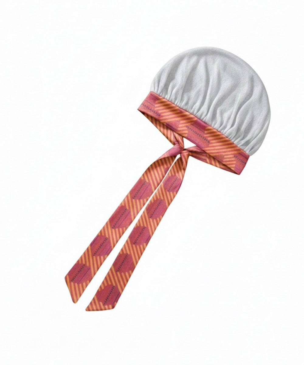 Flat lay of a Lew's Collections satin hair bonnet, featuring a cool white mesh lattice cap and a multicolored 'Aztec Afrique' adjustable satin tie band with a knot.