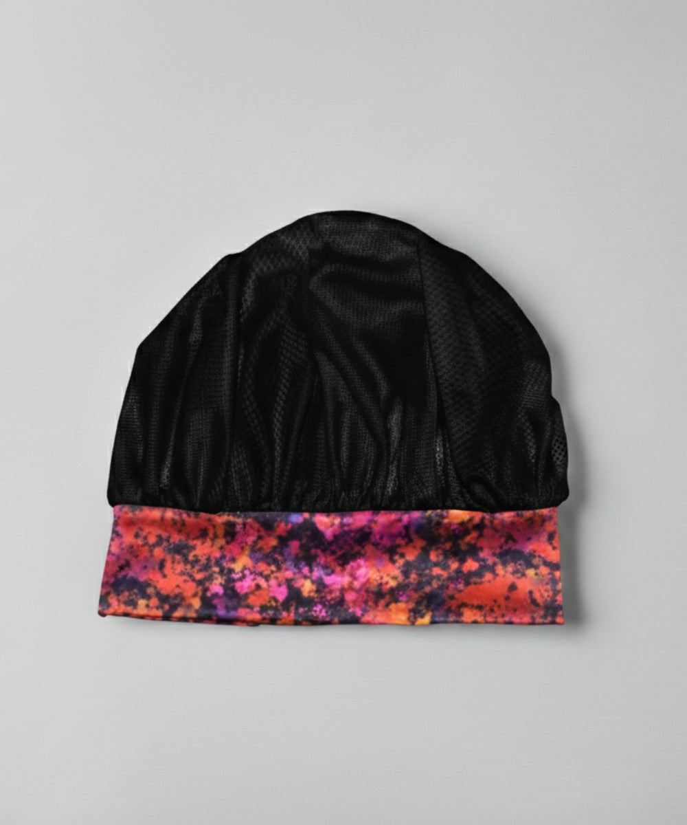 Flat lay of a Lew's Collections satin hair bonnet, featuring a classic black mesh lattice cap and a multicolored 'Cloudy Blossom' satin band.