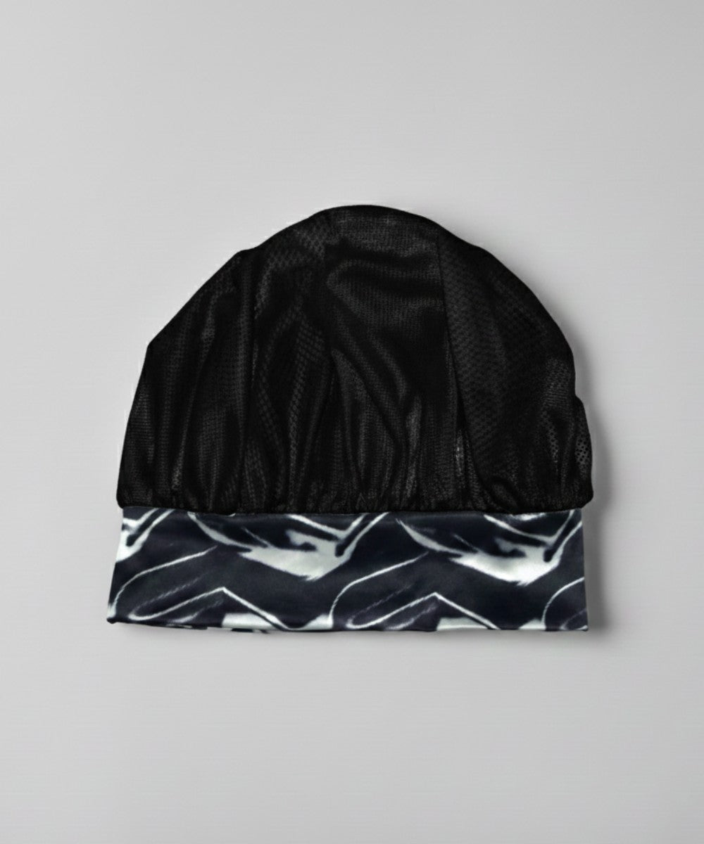 Flat lay of a Lew's Collections satin hair bonnet, featuring a classic black mesh lattice cap and a multicolored 'Marble Noir' satin band.