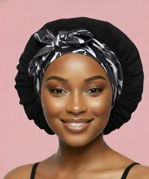Adjustable tie satin hair bonnet with Marble Noir band and black lattice body, offering customizable fit for secure overnight hair protection while sleeping.

